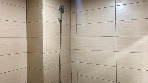 a bathroom with a shower with a shower head at Comfort Studio Room at Margonda Residence 5 Apartment By Travelio in Depok