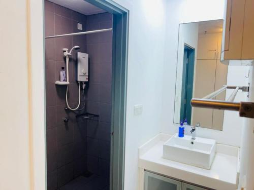 a bathroom with a sink and a shower at Mercu Summer Suites Kuala Lumpur Bukit Bintang By Classy in Kuala Lumpur