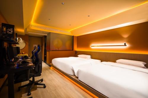 a hotel room with two beds and a desk at Super Time Trendy Design Hotel Guangzhou Beijing Road Pedestrian Street Dafo Temple Branch in Guangzhou