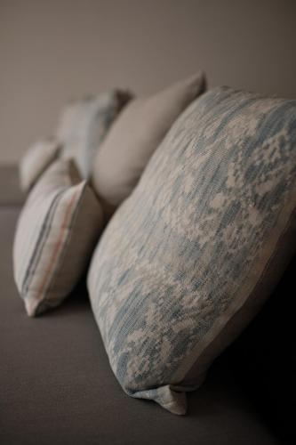 a group of pillows sitting on a bed at New Little Ripper Boutique Hotel in Tanah Lot