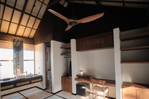 a bathroom with a ceiling fan and a sink at New Little Ripper Boutique Hotel in Tanah Lot