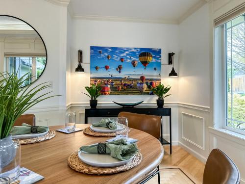 a dining room with a table and chairs and a painting at Soaring Spirit - Hot Tub, Pool Table, Arcades, 2 kitchens in Walla Walla