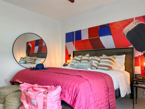 a bedroom with a large bed with a large mirror at Soaring Spirit - Hot Tub, Pool Table, Arcades, 2 kitchens in Walla Walla