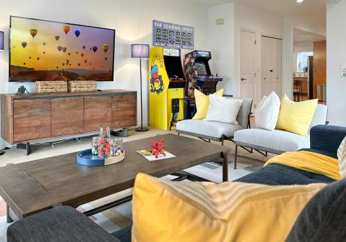 a living room with a flat screen tv and a couch at Soaring Spirit - Hot Tub, Pool Table, Arcades, 2 kitchens in Walla Walla