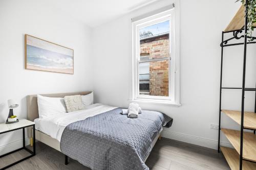 a small bedroom with a bed and a window at Rustic Double Room - Central Location in Kensington - Shared Bathroom in Sydney