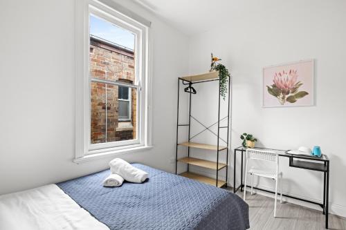 a bedroom with a bed and a desk and a window at Rustic Double Room - Central Location in Kensington - Shared Bathroom in Sydney