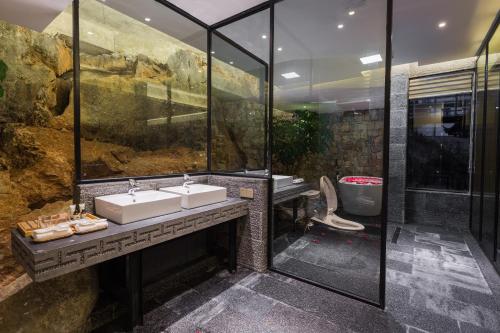 a bathroom with two sinks and a shower at Dali Muhai Island Designer Seaview Manor in Dali