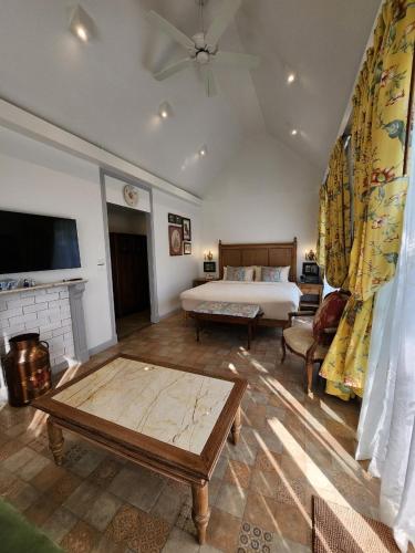 a large bedroom with a bed and a fireplace at La Campagne Villa Chiangmai in Chiang Mai