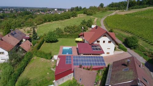 an aerial view of a house with solar panels on its roof at Schwarzwaldtraum am Weinberg in Sasbachwalden