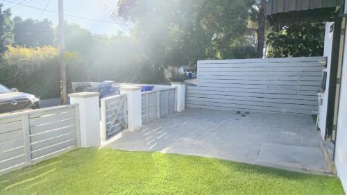 a white fence next to a yard with green grass at Exotic home 2bed 1 bath by sdstay in Lemon Grove