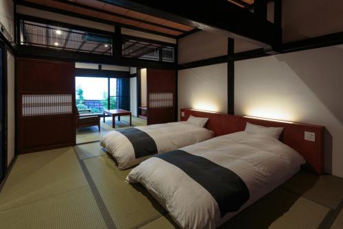 ein Schlafzimmer mit zwei Betten in einem Zimmer in der Unterkunft ryugon in Minami Uonuma