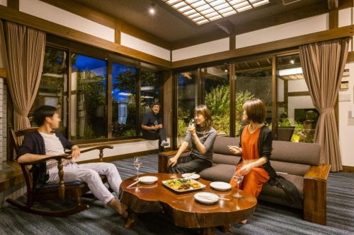 a group of people sitting in a living room at Ryugon in Minami Uonuma
