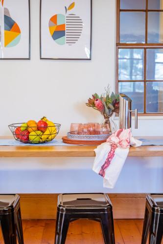 a table with a bowl of fruit on top of it at CLAYFIELD HOMESTEAD - rustic country accommodation in Bishopsbourne