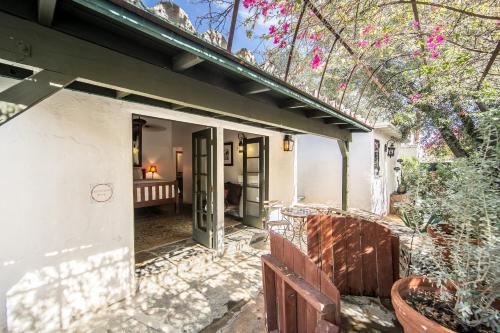 a porch of a house with a door open at Korakia Pensione in Palm Springs