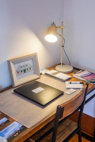 a desk with a laptop and a lamp on it at CLAYFIELD HOMESTEAD - rustic country accommodation in Bishopsbourne