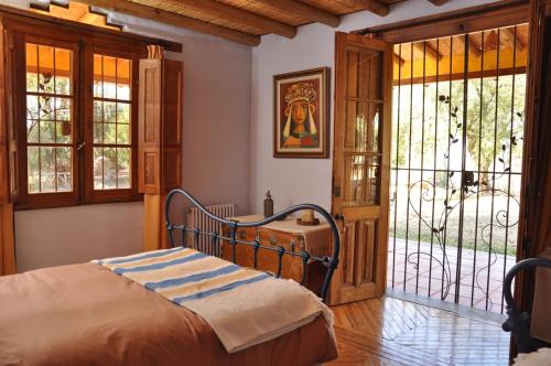 a bedroom with a bed and a sliding glass door at Finca La Encantada in San Rafael