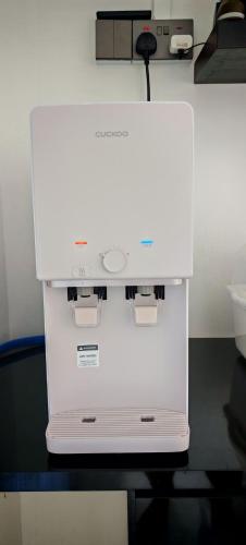 a white machine sitting on top of a table at 23 Inn Singlebed Share Bathroom No Window in Bukit Mertajam