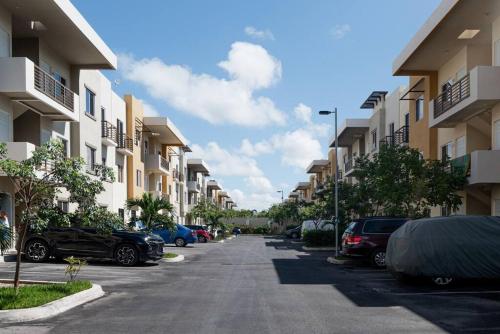 a street with cars parked in a parking lot at Departamento Colibrí in Playa del Carmen