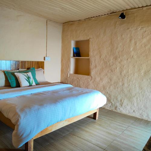 a bedroom with a large bed in a room at Cafe Buransh in Sari