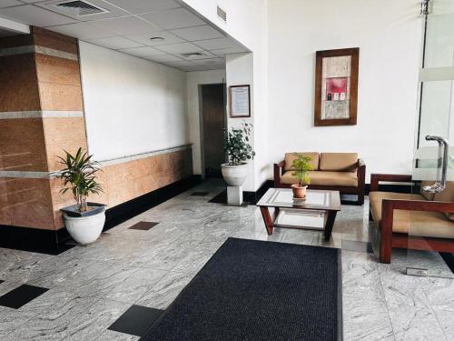 a lobby with couches and a table in a building at Hedges Court Residence -Lotus View - in 5th Floor in Colombo