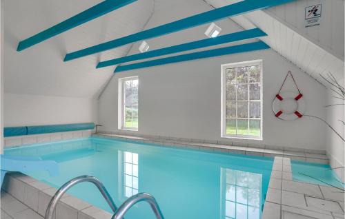 a swimming pool in a house with blue ceilings at Beautiful Home In Ulfborg With Wifi in Husby