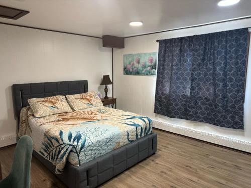 a bedroom with a bed and a blue curtain at Kings Studio Apartment B in Nome