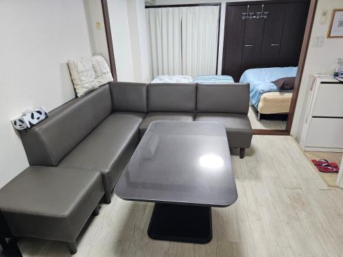 a living room with a couch and a table at YOYOGi STAY in Tokyo