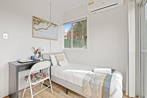 a bedroom with a bed and a desk and a window at Single Room - Quaint Spot in Marayong - Centrally Located - Shared Bathroom in Blacktown