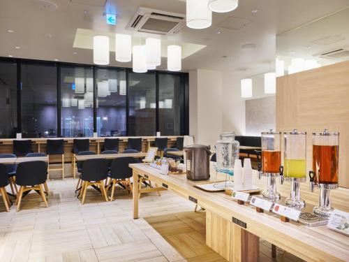 a restaurant with a long table with glasses on it at hotel MONday Asakusa in Tokyo