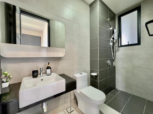 a bathroom with a white sink and a toilet at Cozy Urban Suites Georgetown View in Jelutong