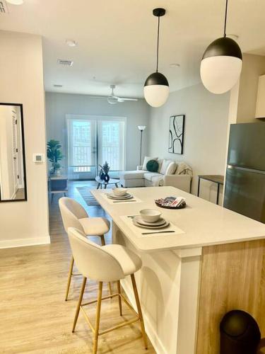 a kitchen and living room with a table and chairs at Cozy Modern 1 Bedroom Apartment in Davenport