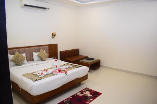 a bedroom with a bed and a chair in it at Hotel Royal Palace in Sāgar