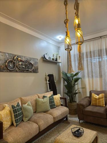 a living room with a couch and a table at Gamaleo Apartment Namulanda in Namulanda