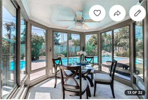 a dining room with a table and chairs and a pool at Relaxing 3-room Apartment with yard pool, Near Santana Row in San Jose