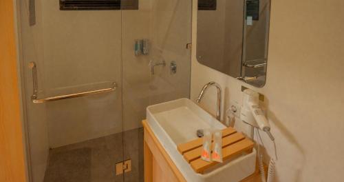 a bathroom with a sink and a shower at Bobocabin Cikole, Bandung in Lembang