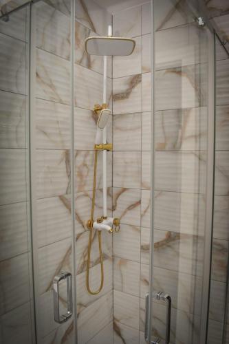 a shower with a glass door in a bathroom at Apartman PLAN B in Banja Luka