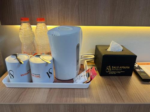a tray with bottles and other items on a shelf at SALU AMAANA Residence Syariah in Wonosobo