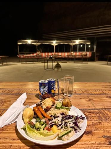 a plate of food on a wooden table at The quiet desert in Wadi Rum