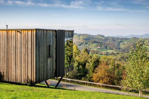 a house on a hill with a view of a road at WURZENBERG Hotel Lodges Südsteiermark in Gamlitz