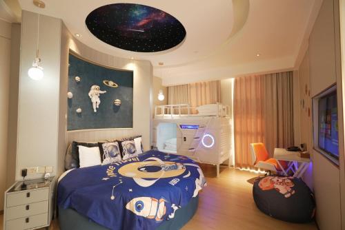 a bedroom with a bed with a blue comforter and a room with at Best Boutique Hotel in Nanhui