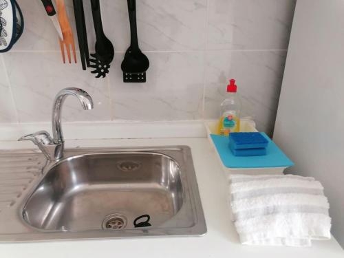 a kitchen counter with a sink and utensils at Simple but cosyBest locations in Vila Nova de Gaia