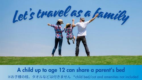 a family holding up a sign that says lets travel as a family at Toyoko Inn Nagoya Meieki Minami in Nagoya