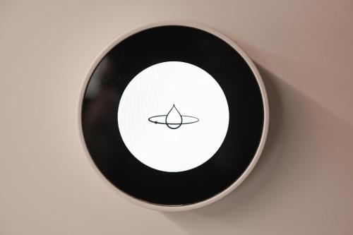 a black and white wall clock with a black at Tiny House Pioneer 3 - Green Tiny Spot Friesland in Schortens