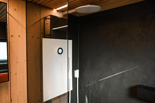 a door in a room with a black wall at Tiny House Pioneer 4 - Green Tiny Spot Friesland in Schortens
