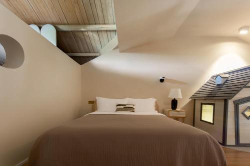 a bedroom with a large bed in a attic at Mila Qi Ting Li Guest House Shanghai in Shanghai