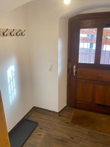 an empty room with a door and a window at Ferienwohnung Bergblick Flirsch in Flirsch