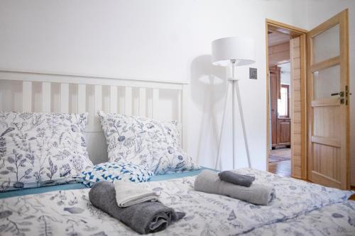 a bedroom with a bed with towels on it at Doberek Noclegi w Beskidzie Niskim in Kobylanka