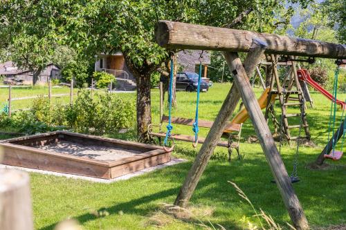 a park with a playground with a swing at AlpenApart Montafon - Alti Saga in Tschagguns
