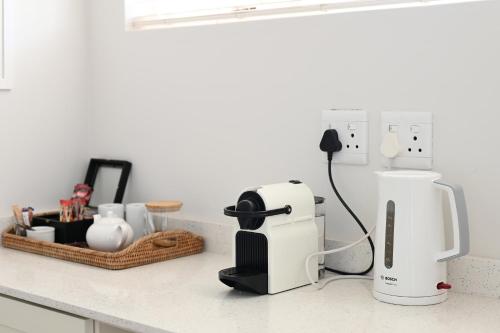 a kitchen counter with a coffee maker on a counter at Fransvliet Guest House in Franschhoek