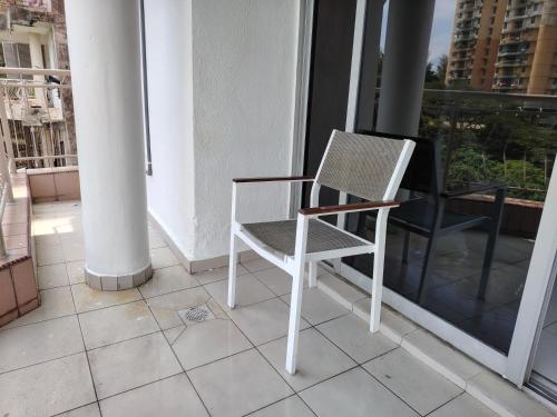 a white chair sitting on top of a balcony at 2R 1B Venice Hill Cheras Room1 & Room2 in Cheras